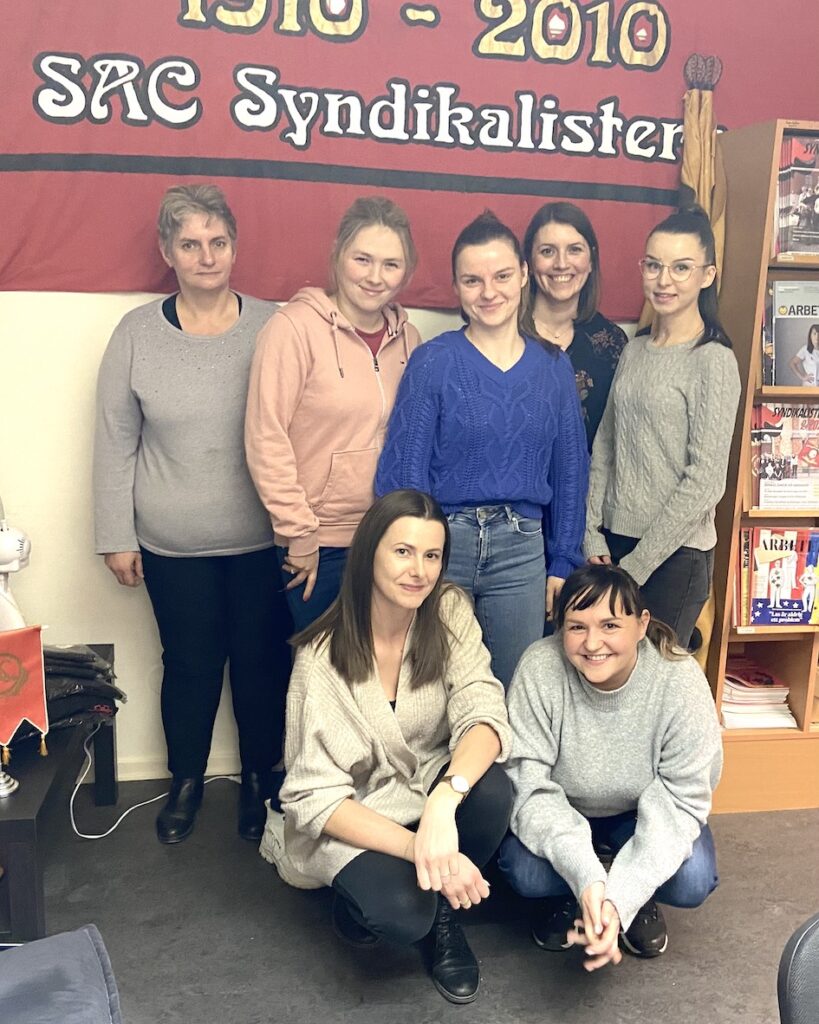 Foto på sju personer som är medlemmar i fackföreningen Göteborgs LS av SAC Syndikalisterna. De är också aktiva i fackklubben för deras arbetsplats där de är städarbetare.